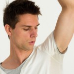 Man sweating very badly under armpit and pointing there