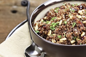 Bowl of Quinoa Pilaf with parsley, pine nuts and cranberries.